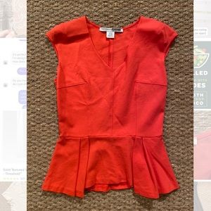 Sleeveless coral peplum top